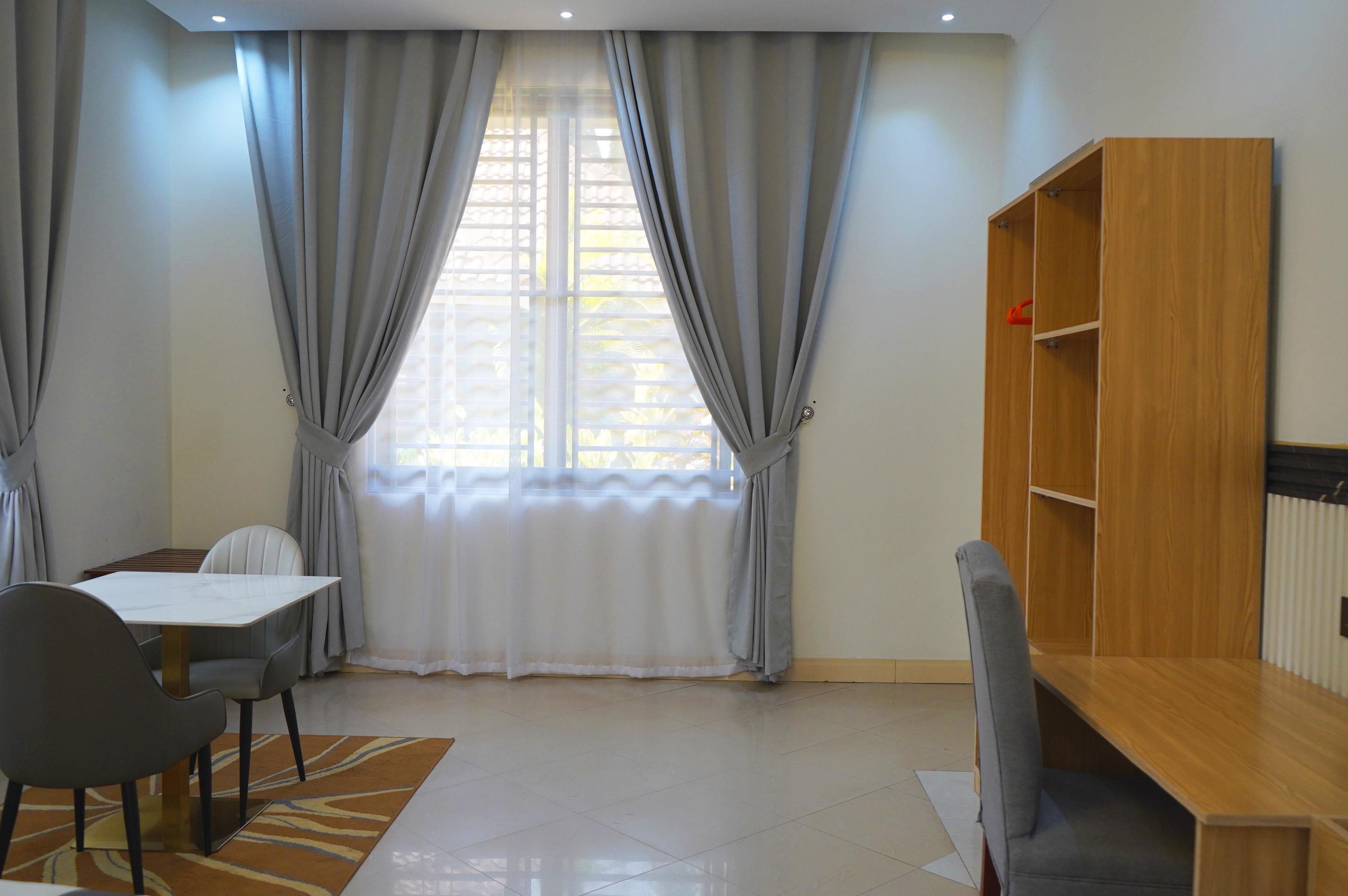 Room workspace and dining chair beside a bright window